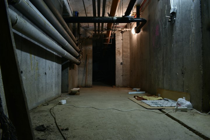 Damp basement concrete floor and foundation walls with microbial staining in Lincoln NE