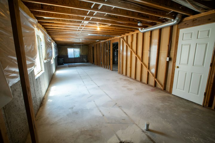 Basement floor flooded with groundwater requiring water extraction and mold mitigation