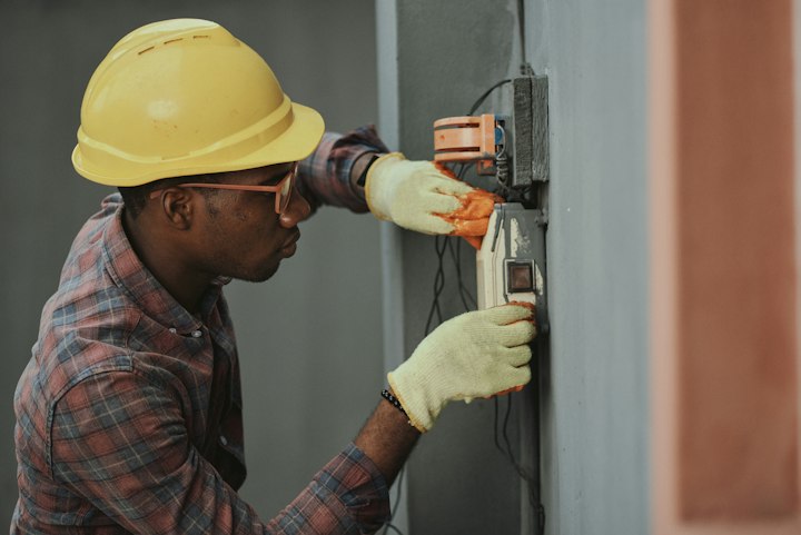 Technician checking wood moisture content on basement framing sill plate